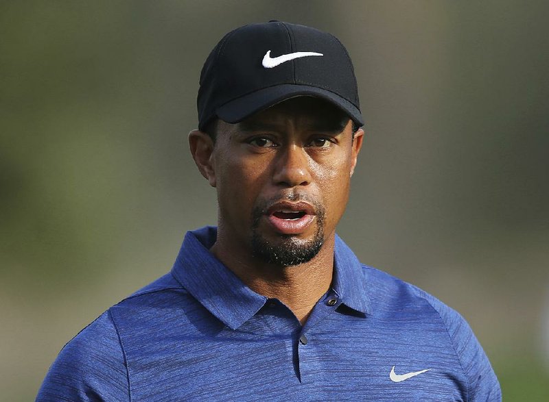 In this  Feb. 2, 2017 file photo, Tiger Woods reacts on hole 10th during the 1st round of the Dubai Desert Classic golf tournament in Dubai, United Arab Emirates. 