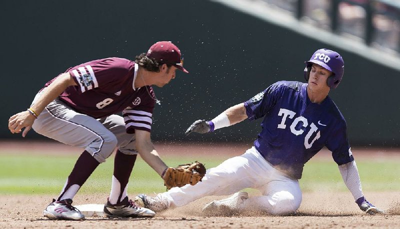 TCU’s Nolan Brown (right) slides safely into second base ahead of a tag by Texas A&M second baseman Braden Shewmake on Tuesday during the Horned Frogs’ 4-1 victory over the Aggies in Omaha, Neb.