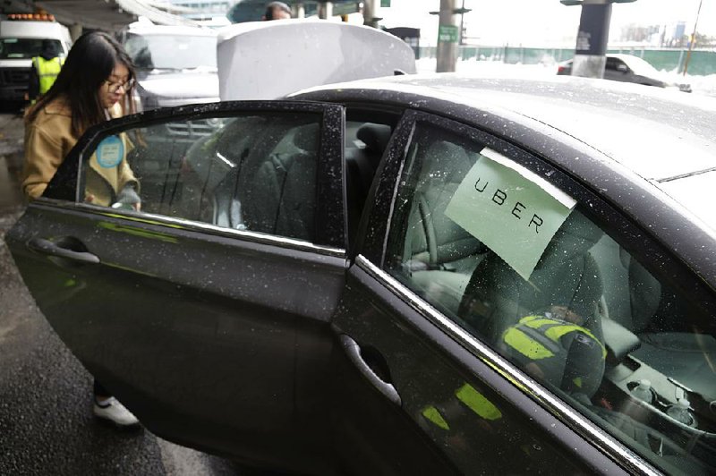 A woman gets in an Uber car at LaGuardia Airport in New York in this file photo. Uber Technologies Inc. said Tuesday that riders in the United States will soon be able to tip drivers using the Uber app. 