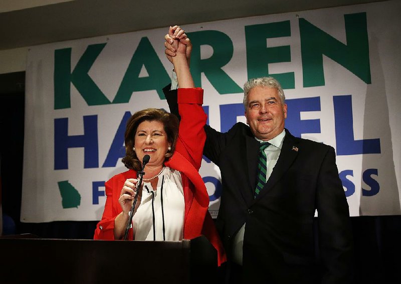 Karen Handel celebrates with her husband, Steve, at her watch party Tuesday night in Atlanta after declaring victory in a House race that broke records for campaign spending.