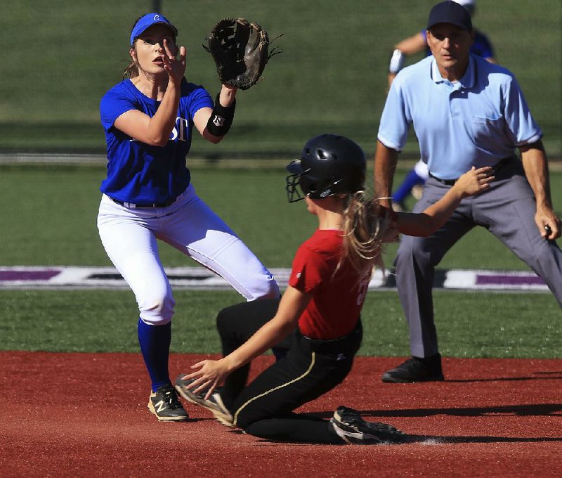 West baserunner Daly Dufresne slides into second base as East inÿelder Lindsey Williams waits on the throw Tuesday in Conway.