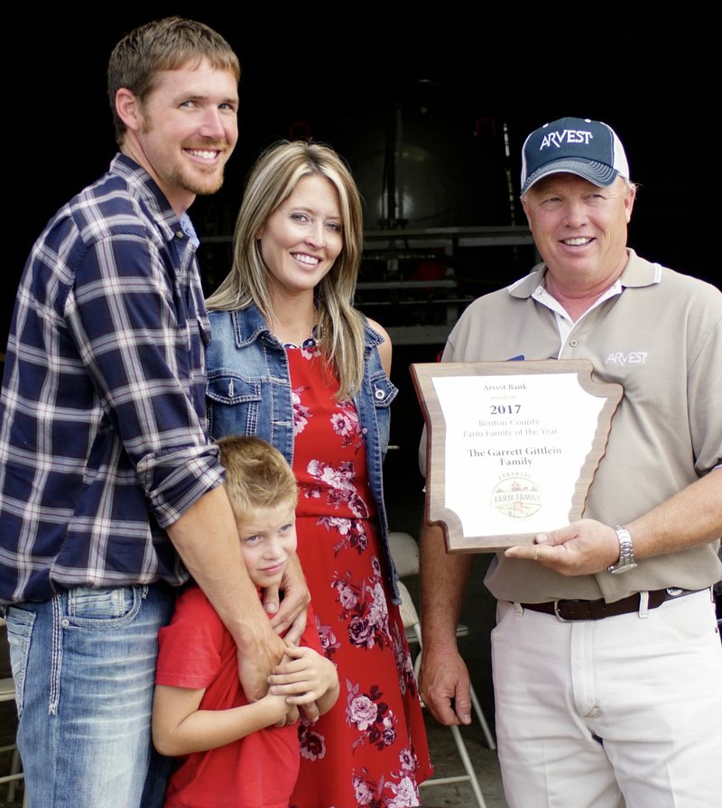 Photo by Randy Moll Garrett and Amanda Gittlein, with their sons, Mason (6) and Colson (3 and not pictured), received a plaque from Jim Singleton honoring them as the Benton County Farm Family of the Year for 2017 at their farm near Maysville on Tuesday, June 13. Singleton is the chairman of the Benton County Farm Family of the Year Selection Committee.