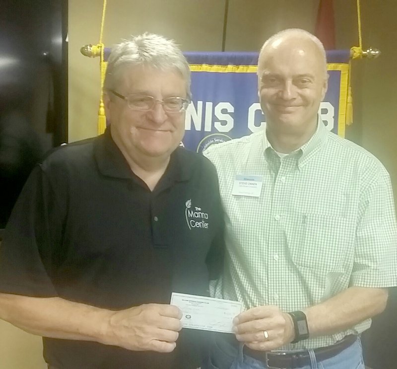 Photo submitted Siloam Springs Kiwanis Club president Steve Onnen, right, presented a check to Mark Brooker, executive director of the Manna Center, for a donation to help the center continue to serve the community. Brooker was the guest speaker to the Kiwanis Club on Wednesday, June 14. The Kiwanis Club meets from noon to 1 p.m. each Wednesday in the Dye Conference Room at John Brown University. Steve Avery, transportation director for the Siloam Springs School District will be the guest speaker on June 21.