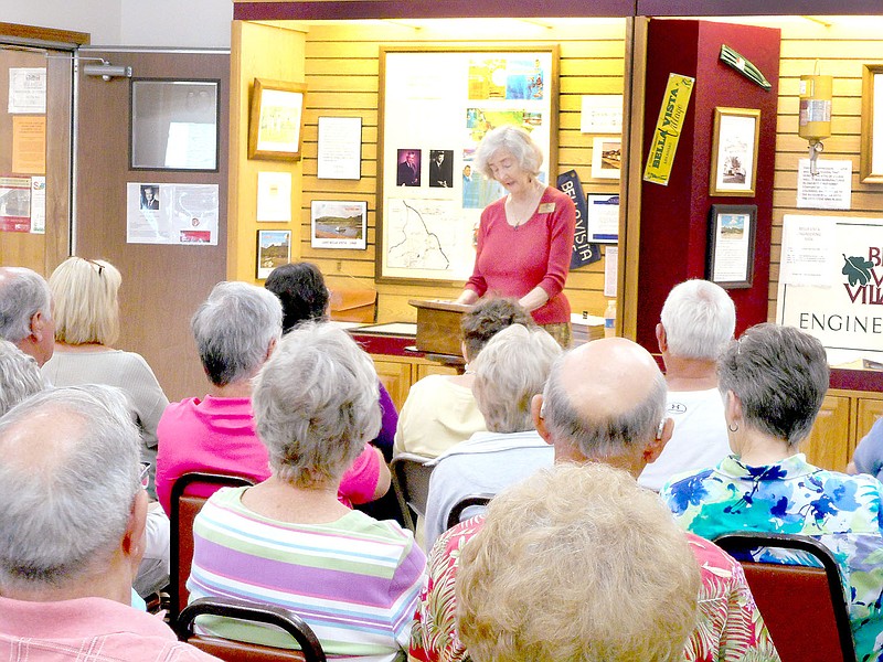 Photo by Xyta Lucas Carole Linebarger Harter, a granddaughter of one of the founders of the Bella Vista Summer Resort, tells Bella Vista Historical Museum patrons the path her grandfather and his brothers took to opening the resort on June 20, 1917. Harter spoke at the museum on Sunday.