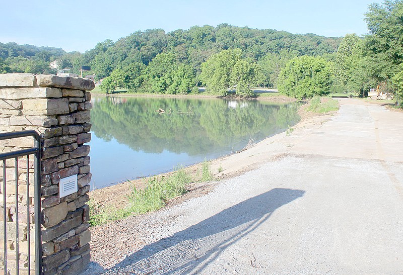 Keith Bryant/The Weekly Vista Millings that covered the dam have been removed and workers are moving into the next job on the Lake Bella Vista Dam.