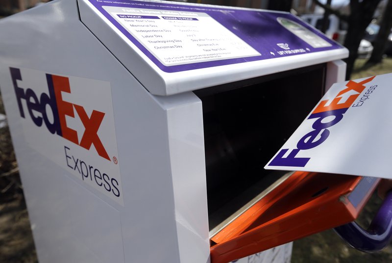 In this April 10, 2017, photo, a FedEx envelope is placed into a dropbox in North Andover, Mass.  (AP Photo/Elise Amendola)