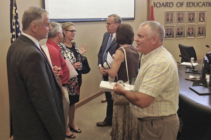 NWA Democrat-Gazette/DAVE PEROZEK Rogers School Board members and Superintendent Marlin Berry (third from right) chat Tuesday after the board meeting in Rogers.