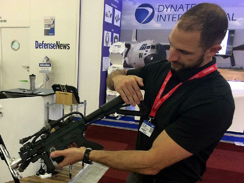 David Romero demonstrates a drone-zapping gun that is part of an anti-drone system his Boise, Idaho, firm is displaying at the Paris Air Show.