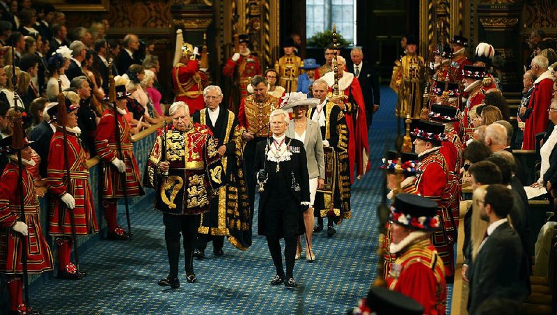 Gentleman Usher of the Black Rod, David Leakey (front right), leads the Queen’s procession through the Royal Gallery to the House of Lords during the State Opening of Parliament on Wednesday in London.

