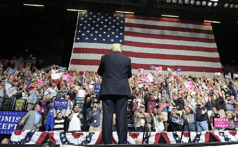 President Donald Trump arrives onstage to speak at the U.S. Cellular Center on Wednesday in Cedar Rapids, Iowa. This is Trump’s first visit to Iowa since the election.