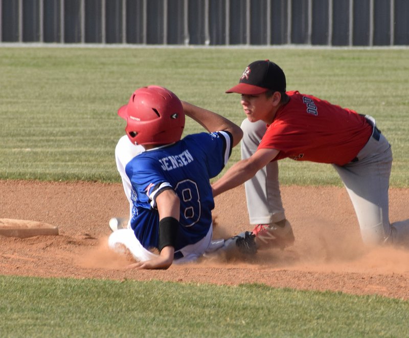 Photo by Rick Peck McDonald County second baseman Cross Dowd puts the tag on a Grove runner during McDonald County&#8217;s 6-0 win on June 13 in Grove.