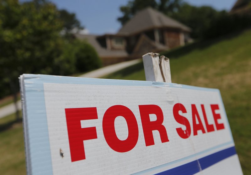 In this Tuesday, May 16, 2017, photo, a sign advertises an existing home for sale in Roswell, Ga. On Wednesday, June 21, 2017, the National Association of Realtors reports on sales of existing homes in May. (AP Photo/John Bazemore)