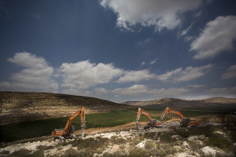 Diggers break the ground for a new settlement near the settlement of Shilo, West Bank, Wednesday, June 21, 2017. Israeli Prime Minister Benjamin Netanyahu said work had begun for the first new Israeli settlement in two decades, to replace Amona, a settlement outpost built on private Palestinian land that was dismantled in February following an Israeli Supreme Court ruling. (AP Photo/Dusan Vranic)