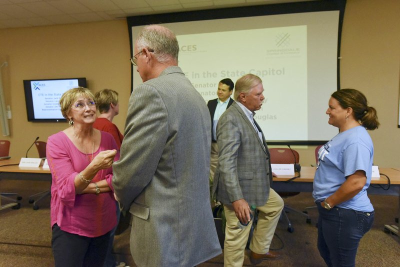 NWA Democrat-Gazette/FLIP PUTTHOFF Debbie Lamb (left) a teacher at Tyson School of Innovation chats Wednesday with State Sen. Jim Hendren while Karla Sprague (right), a teacher at Har-Ber High School, visits with State Rep. Dan Douglas, R-Bentonville, after the panel discussion.