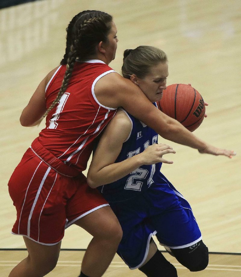 East All-Star Carissa Caples (right) of Rose Bud is fouled by West All-Star Lexi McClellan of Ozark during Thursday’s Arkansas High School Coaches Association All-Star girls basketball game at the Farris Center in Conway. The East used Caples’ 17 points to beat the West 68-58.