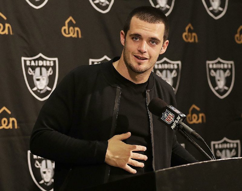 In this Nov. 27, 2016, file photo, Oakland Raiders quarterback Derek Carr speaks at a news conference after an NFL football game against the Carolina Panthers, in Oakland, Calif. 