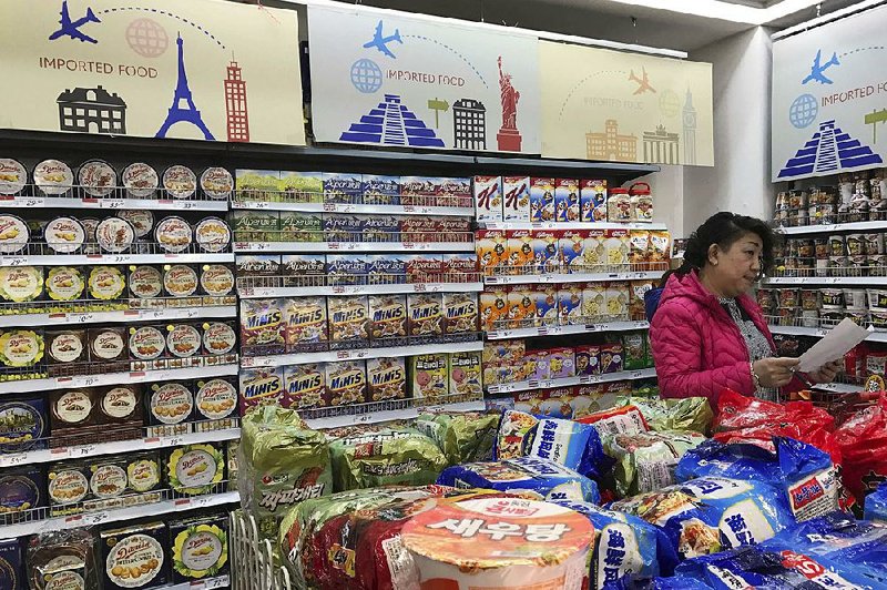 A vendor stocks imported food at a mall in Beijing in March. Chinese regulators are being asked to suspend a proposed requirement that each food shipment to China carry an inspection certificate from the nation of origin.