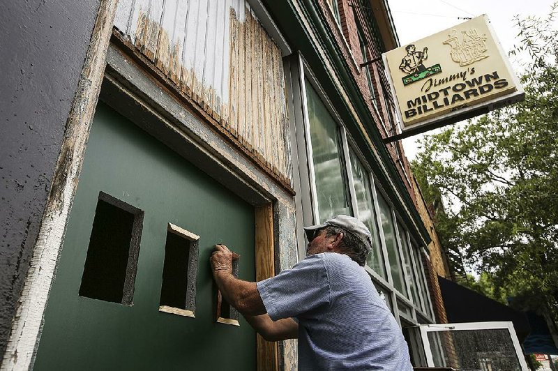 Arkansas Democrat-Gazette/MITCHELL PE MASILUN --6/22/2017--
Johnny Belasco, a carpenter for Metro Disaster Specialists, works on a door at Midtown Billiards in Little Rock Thursday, June 22, 2017.  The establishment is looking to open late next week after a fire destroyed a large part of the location last September. 