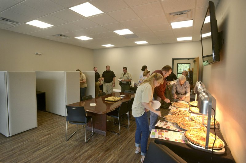 NWA Democrat-Gazette/BEN GOFF • @NWABENGOFF Guests mingle Thursday during an opening for the new Benton County Sheriff's Office Prairie Creek substation on Arkansas 12 near Beaver Lake. A portable blood-alcohol testing machine at the office will make it easier for deputies to deal with drinking and driving boaters on the lake, said Deputy Tony Park.