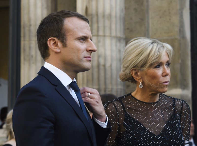 France's President Emmanuel Macron, left, and his wife Brigitte Macron awaiting Colombia's President Juan Manuel Santos and his wife Maria Clemencia Rodriguez for a dinner at the Elysee Palace in Paris, France, Wednesday, June 21, 2017. Nobel Peace Prize winner and Colombian President Juan Manuel Santos starts a three-day visit to Paris for talks on cooperation. (Christophe Petit Tesson/Pool Photo via AP)
