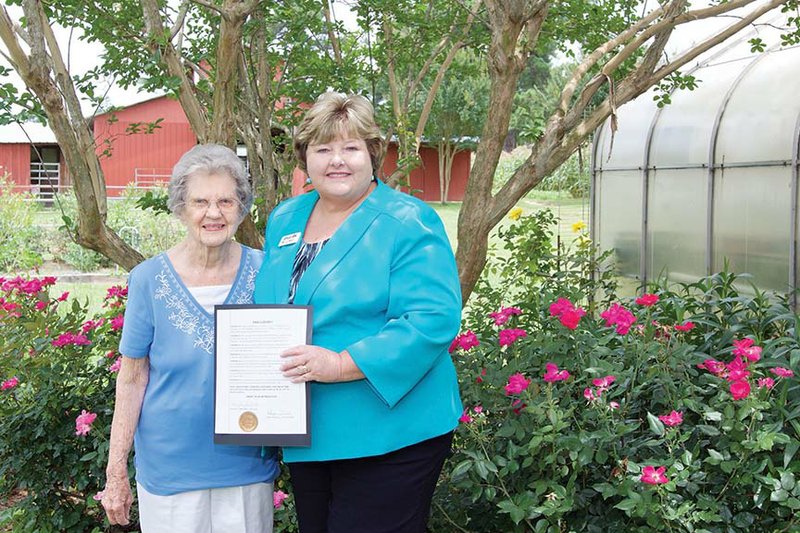 Malvern Mayor Brenda Weldon, right, presents Arkie Remley with the proclamation naming today “Arkie Neal Remley” in honor of her turning 100 years old today. 