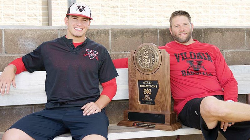 Vilonia baseball player Luke Gordon, left, and coach Brad Wallace are pictured with the Class 5A state championship trophy. Gordon is the River Valley & Ozark Edition Baseball Player of the Year while Wallace is the Coach of the Year.