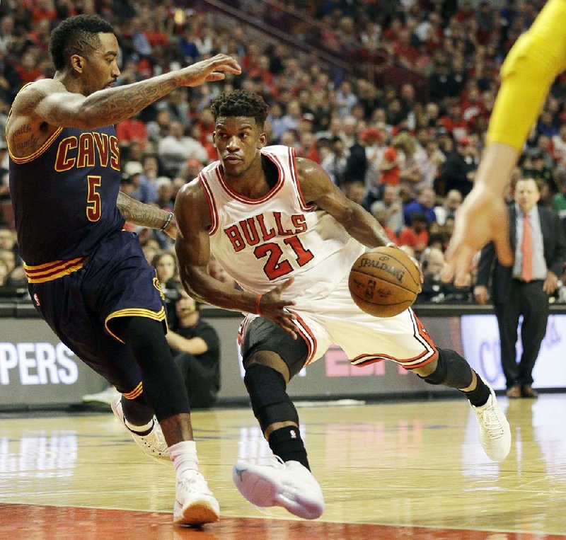 Chicago Bulls guard Jimmy Butler (21) drives against Cleveland Cavaliers guard J.R. Smith (5) during the second half of Game 6 in a second-round NBA basketball playoff series in Chicago on Thursday, May 14, 2015. 