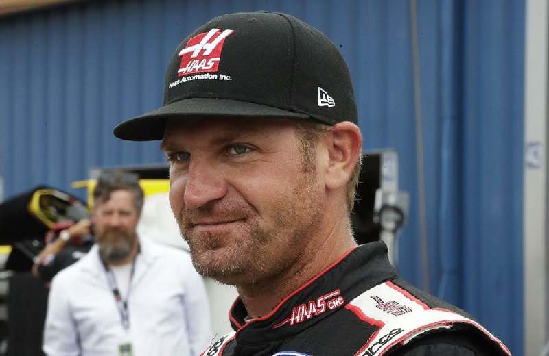 Clint Bowyer walks in the garage area before a practice session, Saturday, June 17, 2017, for the NASCAR Sprint Cup series auto race in Brooklyn, Mich. 