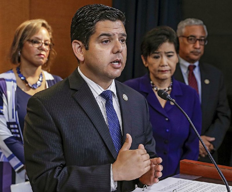 Rep. Raul Ruiz, D-Calif., an emergency room physician, is joined by (from left) Democratic Reps. Robin Kelly of Illinois, Judy Chu of California and Bobby Scott of Virginia during a news conference Friday in Washington on the Senate Republicans’ health care bill.