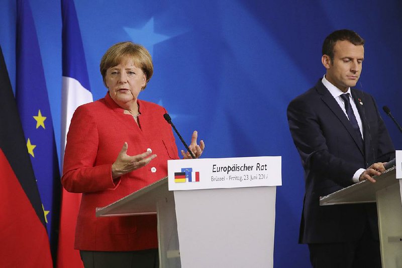 German Chancellor Angela Merkel and French President Emmanuel Macron hold a news conference Friday at an EU summit in Brussels in a demonstration of continental unity.