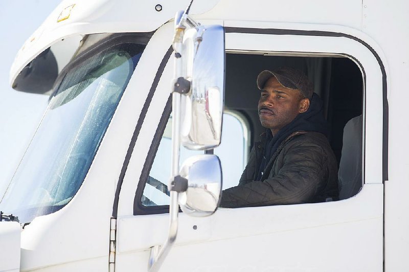 Steven Covington of Bethel Heights checks his mirrors while backing up during a truck driver training course.