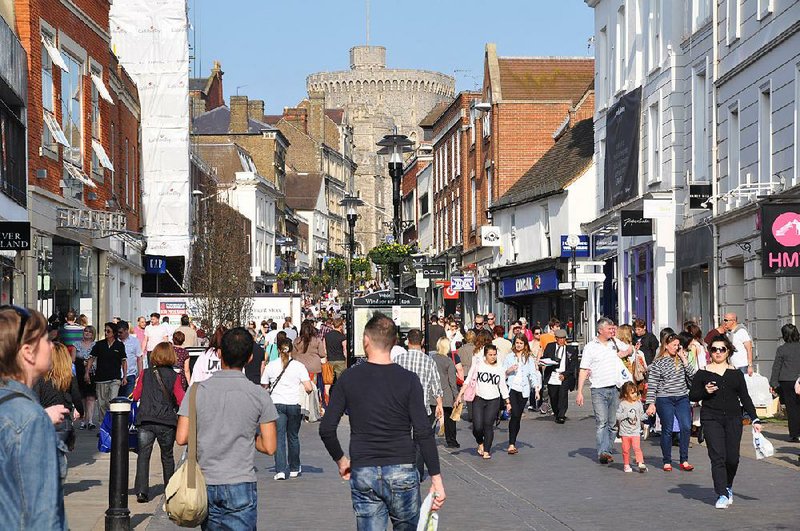 Windsor Castle’s ramparts loom over the town’s shopping street. 