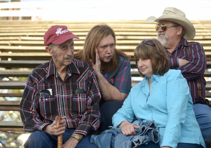 Frank Fitch (from left) sits Friday with his daughter-in-law Betty Fitch, son Nevada Fitch (Betty’s husband), and daughter Latonda Linker, all of Hindsville, during the third night of the Rodeo of the Ozarks at Parsons Stadium in Springdale.