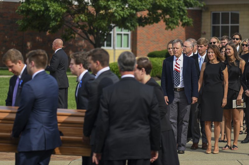 Fred and Cindy Warmbier watch as their son Otto, is placed in a hearse after his funeral, Thursday, June 22, 2017, in Wyoming, Ohio. Otto Warmbier, a 22-year-old University of Virginia student who was sentenced in March 2016 to 15 years in prison with hard labor in North Korea, died this week, days after returning to the United States. (AP Photo/Bryan Woolston)