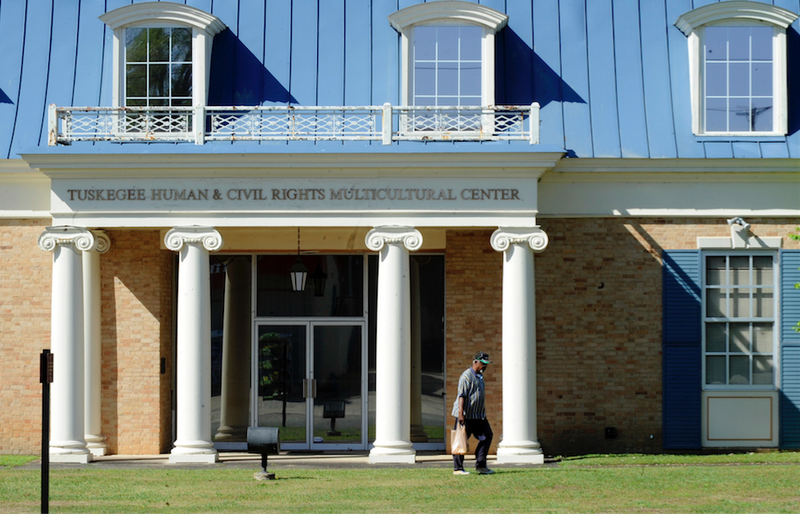In this photo taken Tuesday, April 4, 2017, an unidentified man walks past the Tuskegee Human and Civil Rights Multicultural Center in Tuskegee, Ala. The Trump administration is opposing a bid to use unclaimed money from a legal settlement to fund the museum, which includes exhibits honoring victims of the government's infamous Tuskegee syphilis study. 