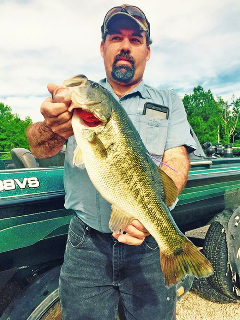 Pete Clark of Malvern shows off a 4-pound largemouth bass that earned him and his brother Jessie $15,000.