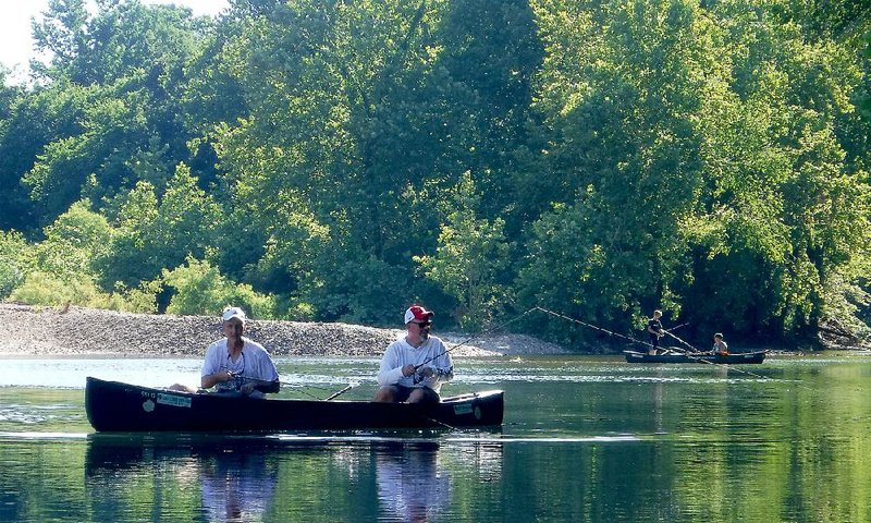 Chris West of Memphis (left) and Joe Volpe of Little Rock try to entice bites from smallmouth bass as Jack Forrest and John Volpe fi sh in the background Tuesday.