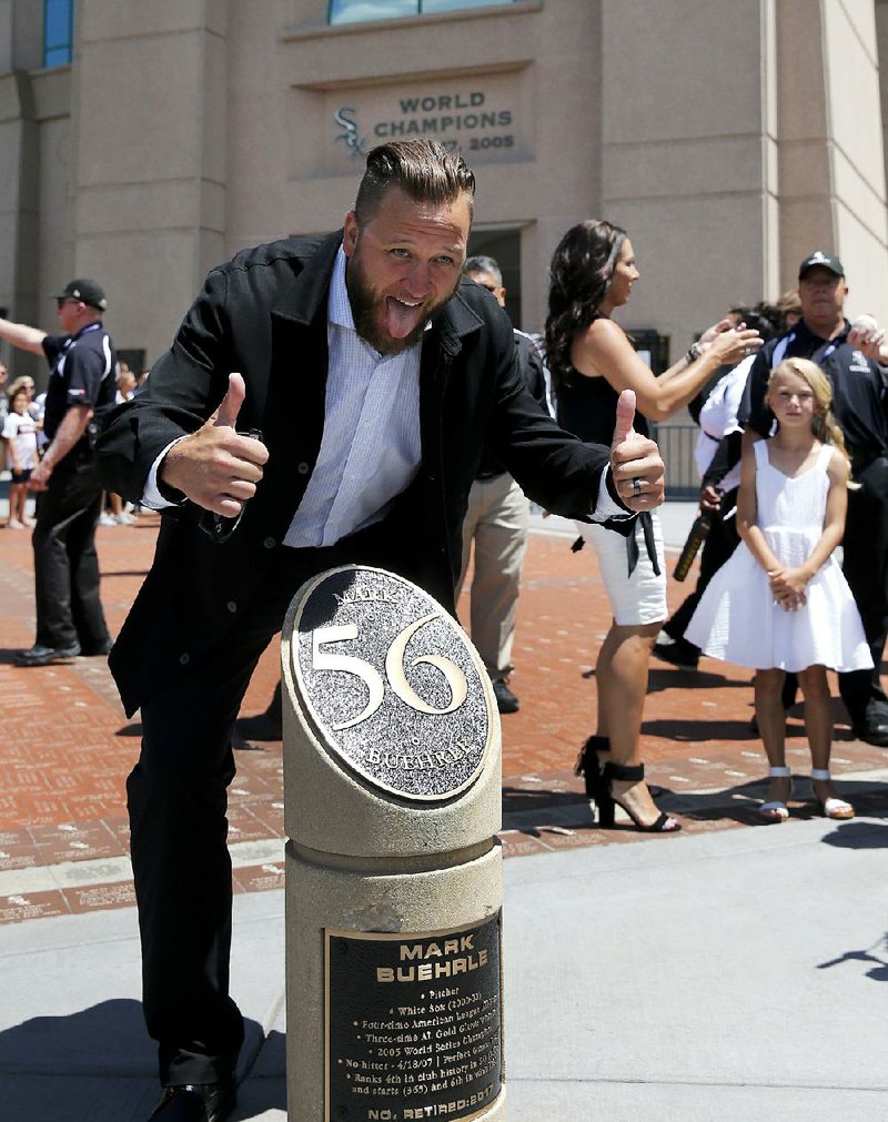 Former Chicago White Sox pitcher Mark Buerhle poses with a monument honoring the retirement of his number
Saturday in Chicago.