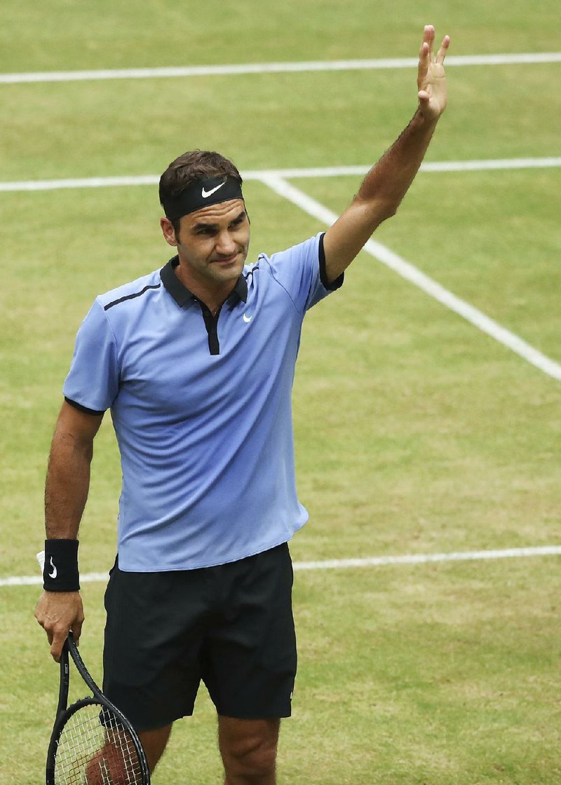 Switzerland's Roger Federer  celebrates his victory  after the semifinal match against Russia's Karen Khachanov,  at the Gerry Weber Open tennis tournament in Halle, Germany, Saturday, June 24, 2017. 