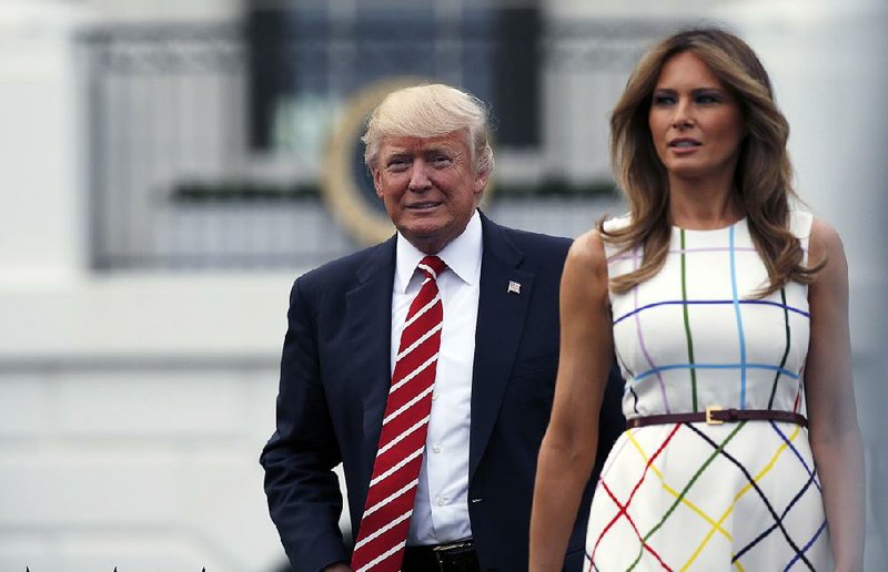 In this June 22, 2017, photo, President Donald Trump with first lady Melania Trump arrives at the Congressional Picnic on the South Lawn of the White House in Washington. 