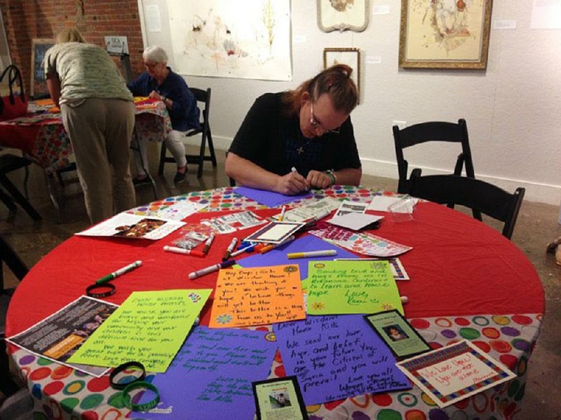 Erin Weindorf of Conway writes a letter to Syrian children as part of The Wisdom House Project, an initiative aimed at supporting and connecting with children in a Syrian preschool. 