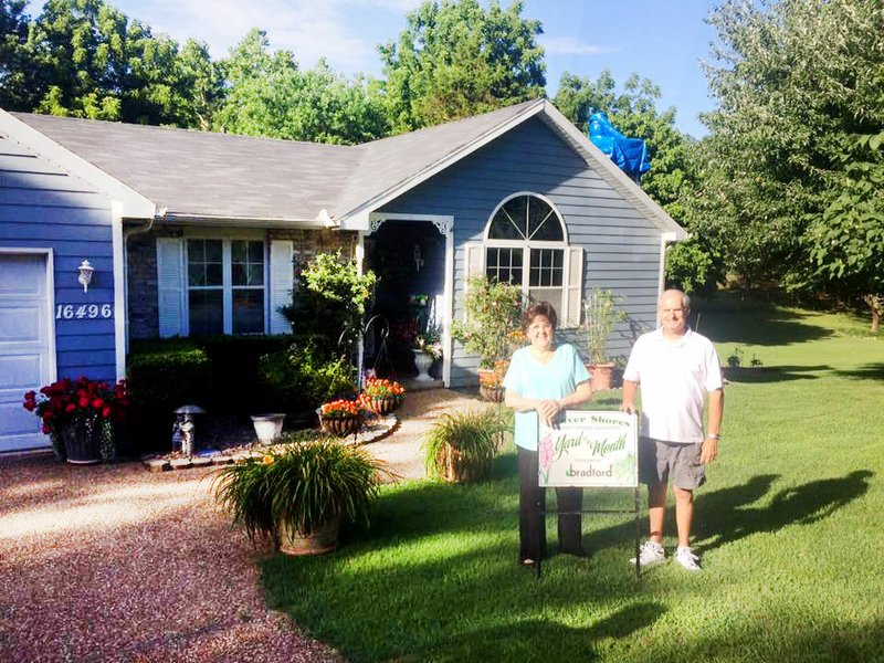 Courtesy photo This month's Beaver Shores POA Yard of the Month recipients are John and Oneeta Keller at 16496 Rainbow Drive in Rogers. The backyard is like a park that is full of plants and flowers. They have been residents since 1993 in Beaver Shores. Bradford Yard and Landscape sponsored the $25 gift card and tool kit.