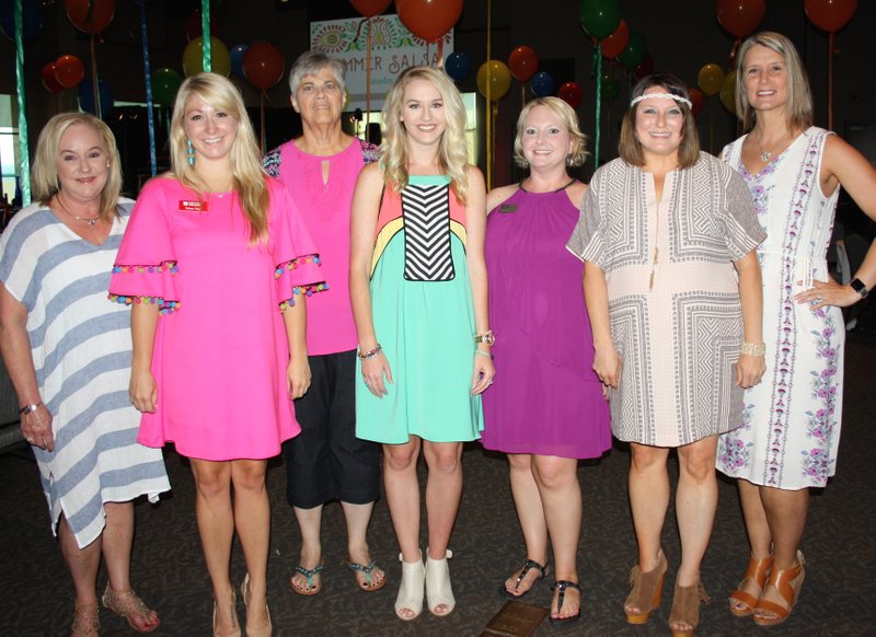 NWA Democrat-Gazette/CARIN SCHOPPMEYER Darcy Smith (from left), Kelsey Tapp, Kathy Crisp, Kalee Cooper, Megan Cuddy, Crystal Butler and Julia Brooks, Summer Salsa committee members, welcome guests to the 15th annual Children's House benefit June 17 at the Fayetteville Town Center.