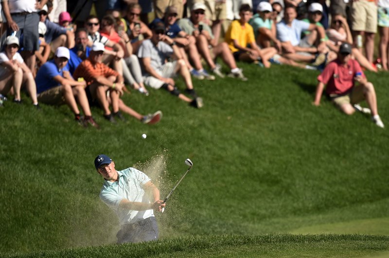 The Associated Press CLEARING THE BUNKER: Jordan Spieth hits from the greenside bunker on the 15th hole during the third round of the Travelers Championship Saturday in Cromwell, Conn.