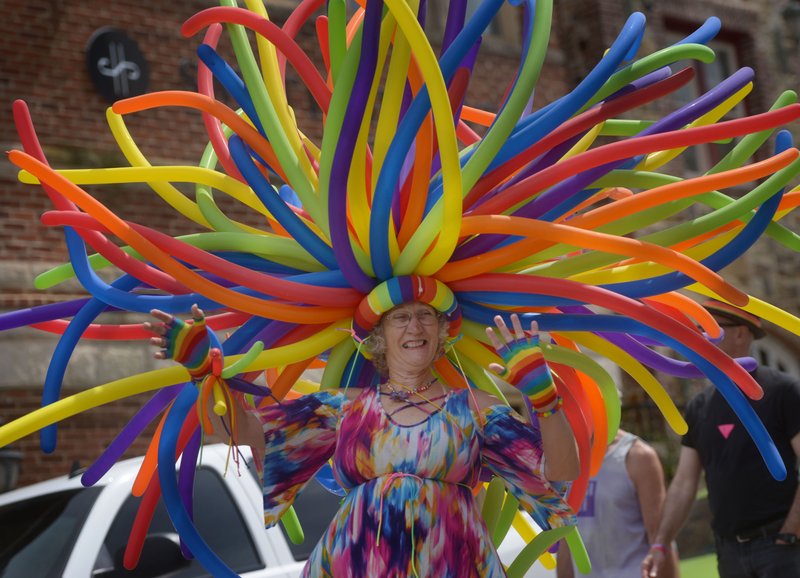 NWA Democrat-Gazette/BEN GOFF @NWABENGOFF
Roxie Howard of Eureka Springs wears hat and tail made from balloons as she walks Saturday with a group from Eureka Springs Pride during the Northwest Arkansas Pride Parade on Dickson Street in Fayetteville. The parade is a highlight of the annual Northwest Arkansas Pride week hosted by the NWA Center for Equality, with events celebrating LGBT diversity and equality in Fayetteville and Bentonville.