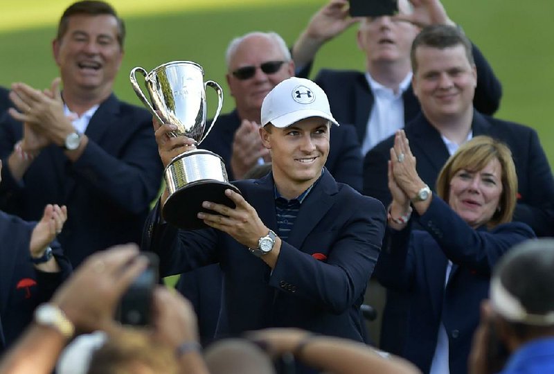 Jordan Spieth holds up the Travelers Championship golf tournament Sunday, June 25, 2017, in Cromwell, Conn.  