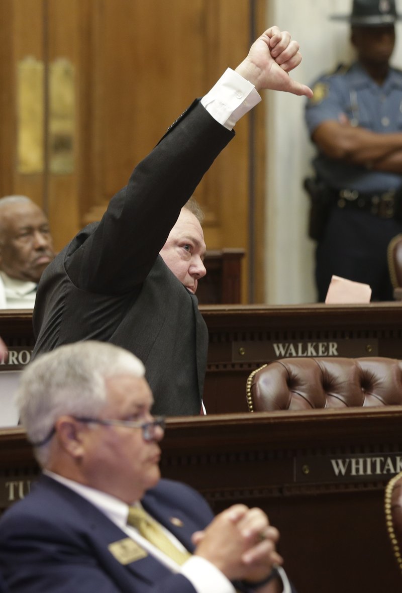 Rep. David Whitaker, D-Fayetteville, center, signals his intention to speak against a bill that chafes Arkansas primary election dates in the House chamber at the Arkansas state Capitol in Little Rock, Ark., Wednesday, May 27, 2015. The bill passed. 