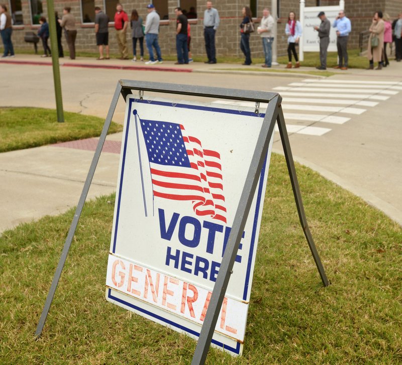 NWA Democrat-Gazette File Photo/BEN GOFF
A line of voters snakes around the block.