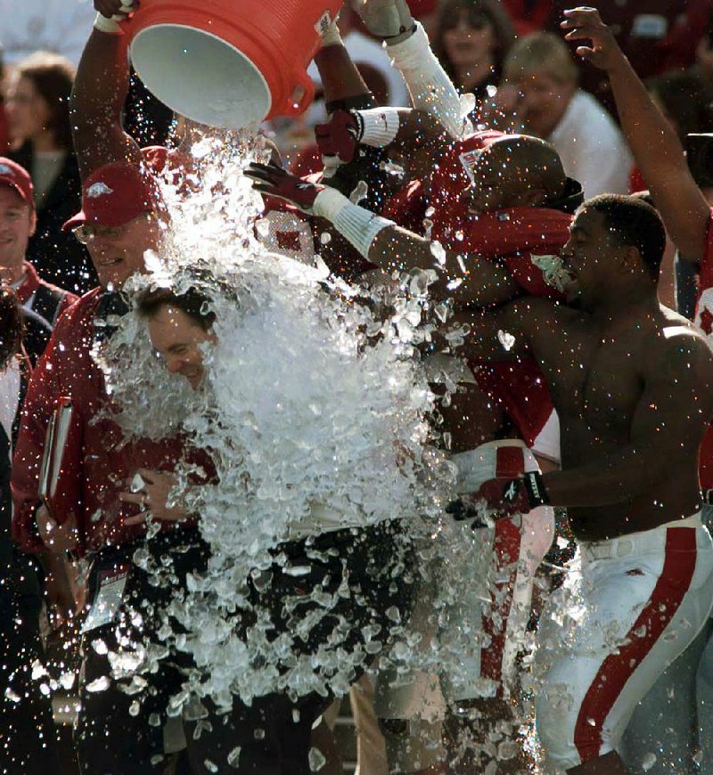 Houston Nutt is doused with a bucket of ice in the closing minutes of the 2000 Cotton Bowl against Texas in Dallas. Nutt, in his second season as the Arkansas Razorbacks’ coach, led the Hogs to a 27-6 victory over the Longhorns.