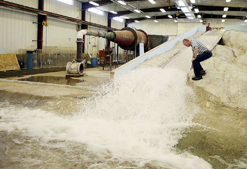 Hydraulic engineering professor Michael Johnson watches water flow through a replica of the Oroville Dam spillway at Utah State University’s Water Research Laboratory in Logan, Utah, on June 16. 